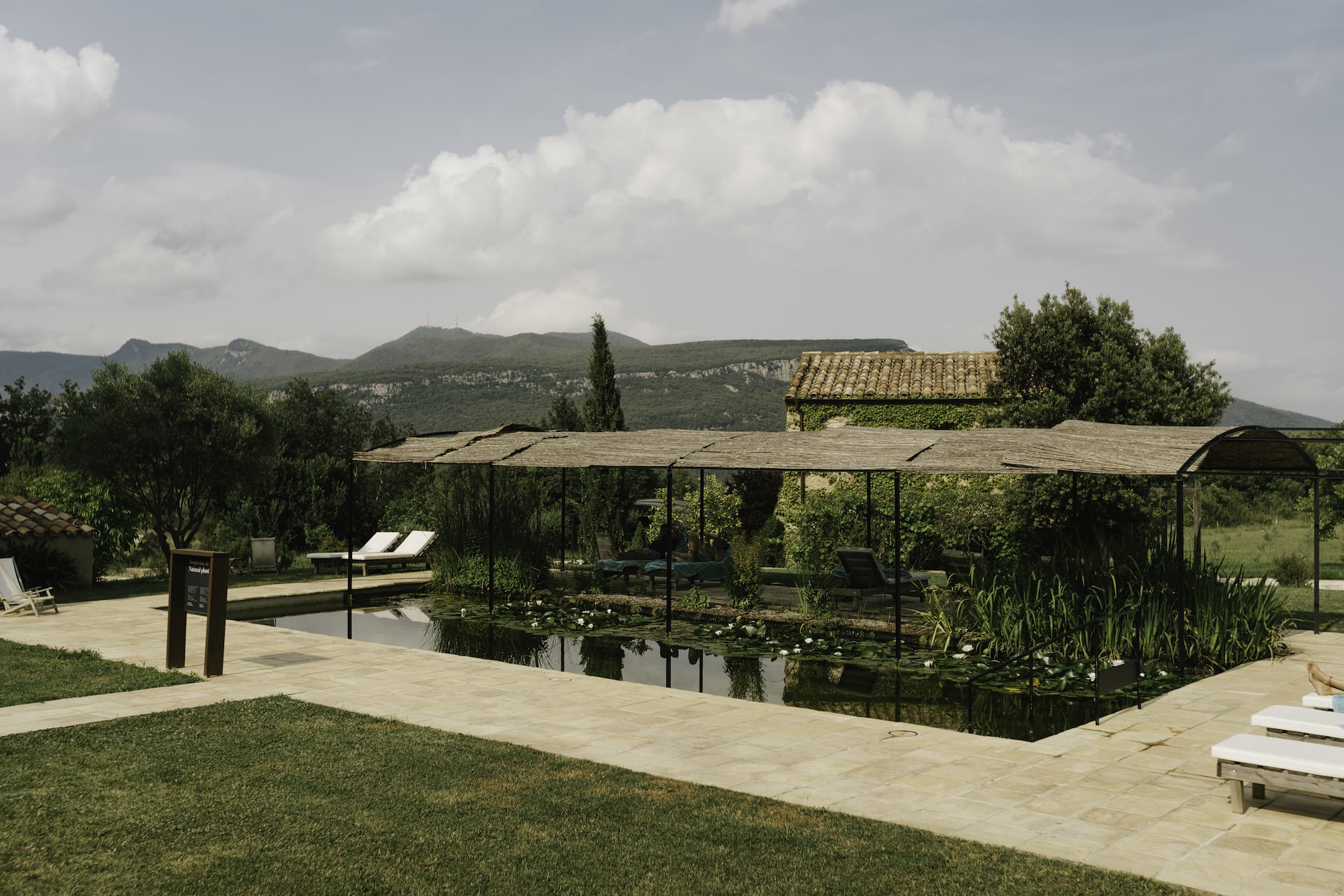 Natural swimming pool at Can Buch Hotel surrounded by nature and mountains in La Garrotxa.